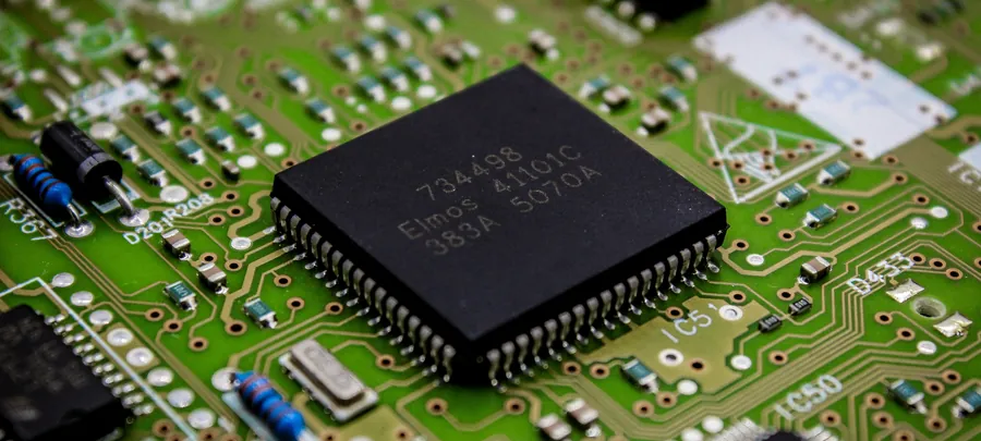 Close-up of a processor chip on a green circuit board